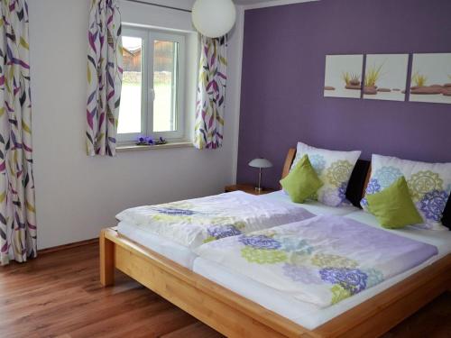 WinzerFerienhof Nirschl的一间卧室设有一张紫色墙壁的大床