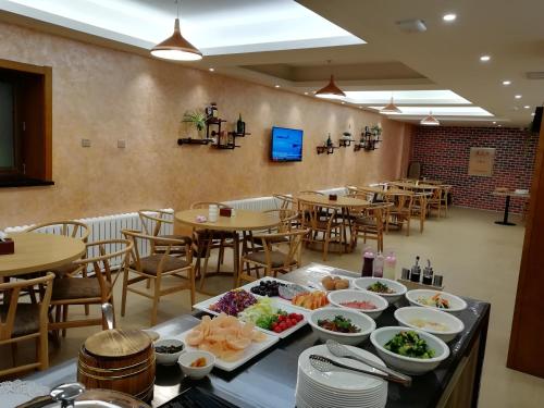 哈尔滨哈尔滨旅悦精品酒店的餐桌上放有盘子的餐厅