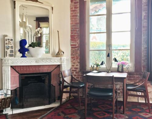 滨海图维列Le Manoir Normand的客厅配有桌子和壁炉