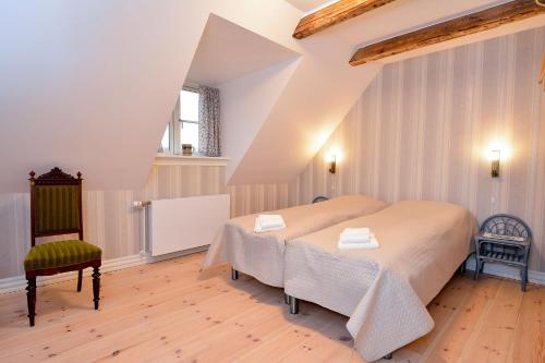 Øster AsselsStrømpehuset的一间卧室配有一张大床和一把椅子