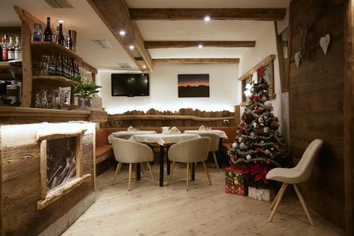 平佐洛拉帕卢酒店的餐厅的圣诞树,配有桌椅