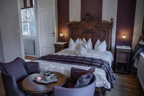 马尔梅迪Dépendance Maison Géron的酒店客房带一张床、一张桌子和椅子