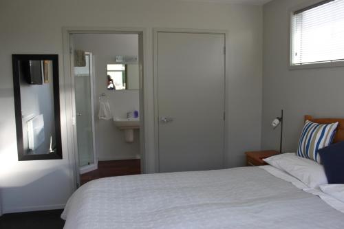 提马鲁逸景住宿加早餐酒店的一间卧室配有一张床,浴室设有水槽