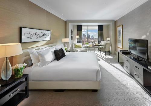 墨尔本Crown Towers Melbourne的大型酒店客房设有床和电视。