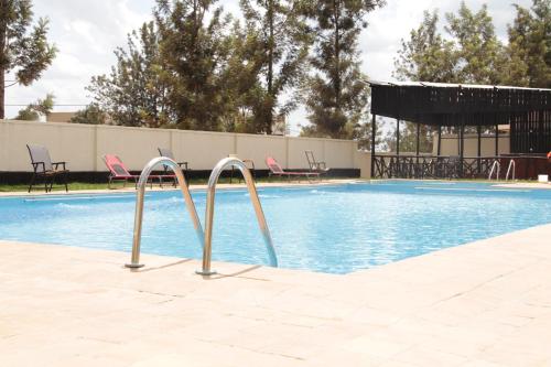 NyagatareNyagatare Diplomat Hotel的游泳池周围设有两个金属棒