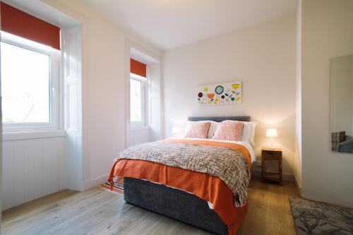 爱丁堡美丽市中心公寓 - 荷里路德公园的一间卧室设有一张床和两个窗户。