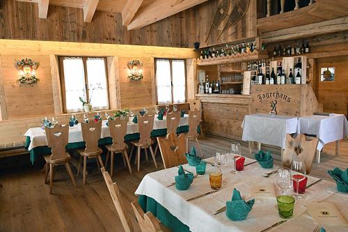 科尔蒂纳丹佩佐农场猎人之家旅馆的一间在房间内配有桌椅的餐厅