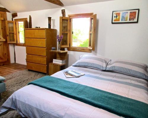 RupkiteLavender Lodge的一间卧室配有一张床、一个梳妆台和一扇窗户。
