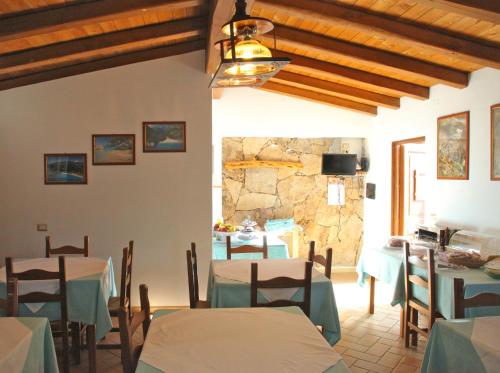 卡拉古诺内玛丽亚卡特里纳乡村别墅旅游酒店的一间设有桌子和石墙的用餐室
