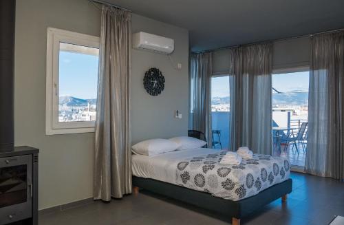 雅典卫城美景处女座阁楼公寓的一间卧室设有一张床和美景窗户。