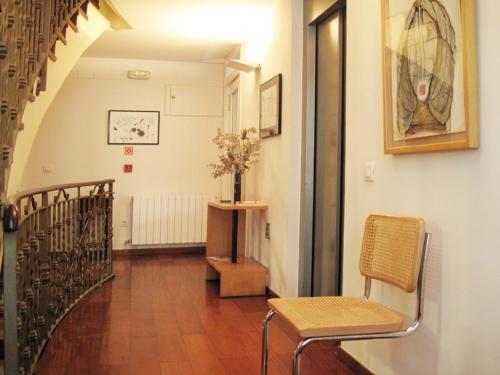 卢安科广场一号酒店的走廊设有楼梯、椅子和桌子