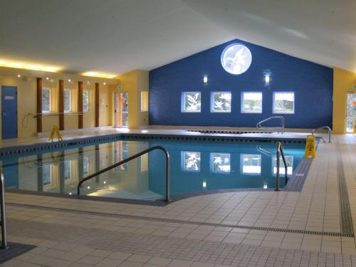 曼宁公园曼宁公园度假酒店的一座带蓝色墙壁的大型游泳池