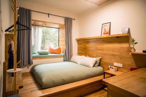 杭州闲处的一间卧室设有一张床和一个窗口