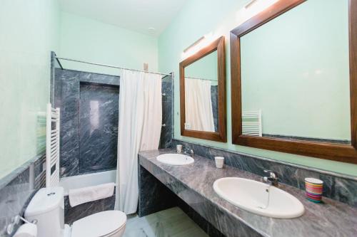 加的斯Apartamentos La Botanica, Cadiz的浴室设有2个水槽、卫生间和镜子。