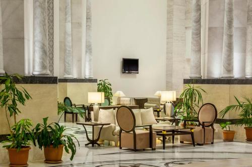 拉瑞梅拉斯拉拉酒店的大堂设有桌椅和盆栽植物