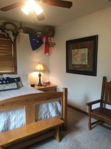 Pipe CreekGlory Hills Ranch的一间卧室配有一张床、一把椅子和一盏灯