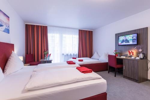美因河畔法兰克福法兰克福市展览中心喜马拉雅酒店的大型酒店客房 - 带两张床和一张沙发