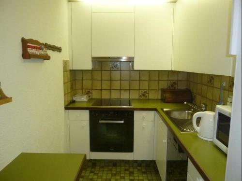 伦策海德La Schmetta 5 (334 Fo)的小厨房配有白色橱柜和水槽