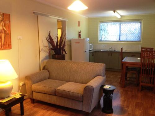 赫维湾海湾椰树酒店的带沙发的客厅和厨房