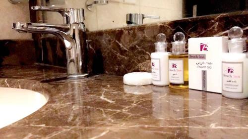 Al QunfudhahBeach Inn的浴室柜台配有水槽和一些肥皂