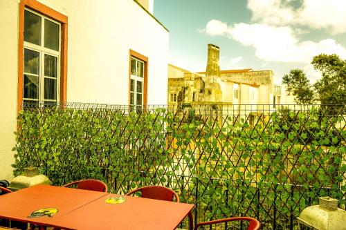 蓬塔德尔加达Azores Dream Hostel的一个带桌椅和围栏的庭院