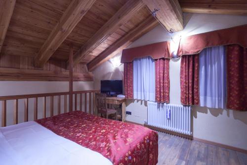 库马约尔圣简马森酒店的一间卧室配有一张床和一张书桌