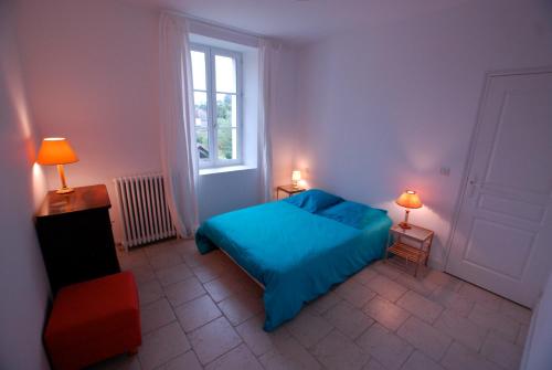 圣艾尼昂Chambres d'Hôtes Les Bords du Cher的一间卧室设有蓝色的床和窗户。