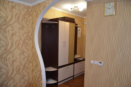 BerdychivВетеринарный的一间带镜子、橱柜和时钟的浴室