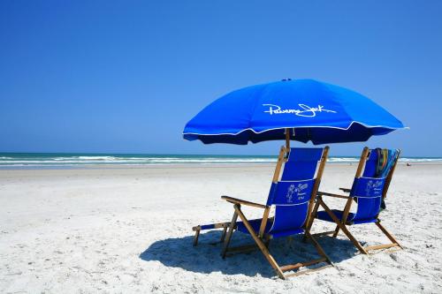 圣奥古斯丁海滩圣奥古斯丁海滩居伊哈维度假酒店的海滩上的两把椅子和一把遮阳伞