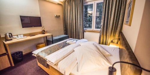 迪马诺卡多林纳河畔酒店的一间医院间,配有一张床和一张书桌