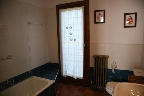 Buera拉芬特旅馆的带浴缸、卫生间和窗户的浴室