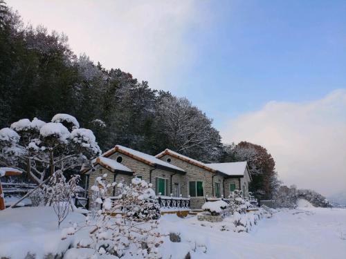 潭阳Chungaram的森林前的雪覆盖的房子