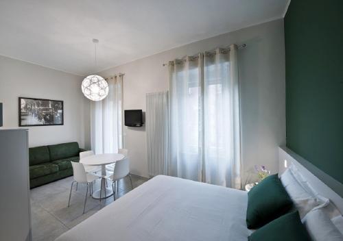 都灵Bacio di Dama Lingotto的一间卧室配有一张床、一张沙发和一张桌子