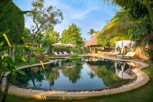 暹粒纳瓦图梦幻疗养度假村的一个带椅子和树木的度假村游泳池