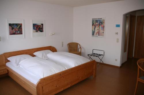 Sontheim im StubentalSontheimer Wirtshäusle的一间卧室配有一张带白色床单的木床