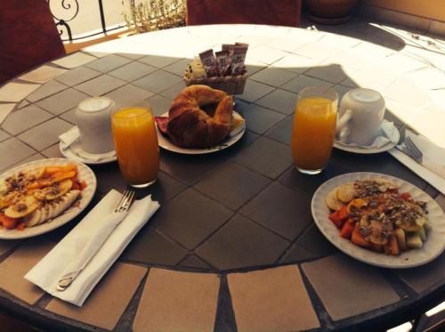 圣米格尔-德阿连德提欧精品酒店的餐桌,带食物盘和橙汁杯