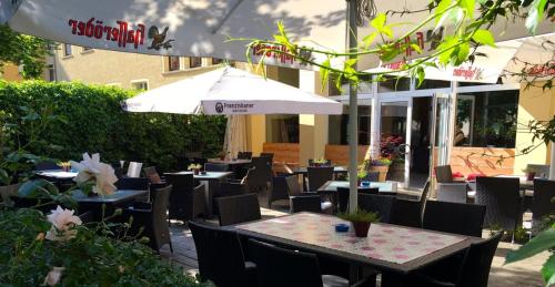 NachterstedtHotel zum Schwan的室外餐厅设有桌椅和遮阳伞。