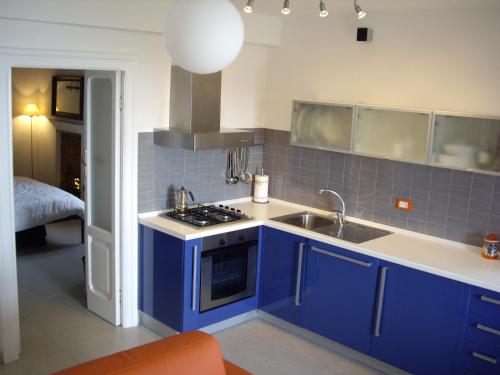 圣维托基耶蒂诺Sea view apartment 10 minute walk to the sea的蓝色的厨房设有水槽和炉灶