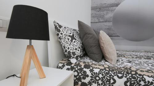 米兰纳维格利里帕蒂希内斯P&D公寓的一间卧室配有带枕头和台灯的床