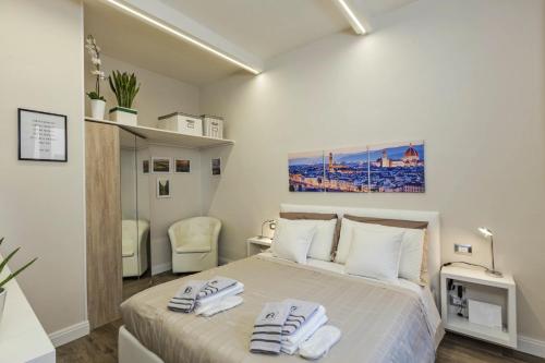 佛罗伦萨Little Suite Fortezza的一间卧室配有带毛巾的床