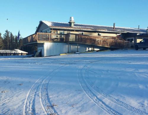 荷马贝鲁加湖旅舍的前面的雪中有轨迹的房子