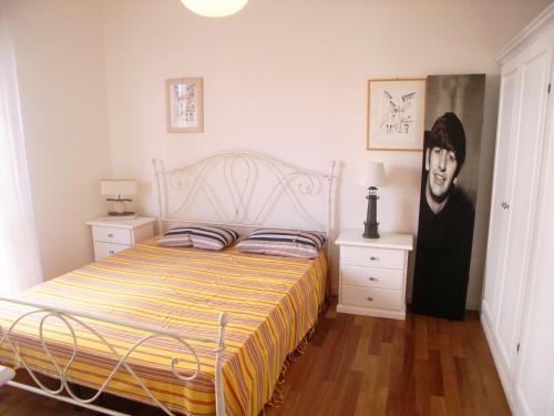 格拉多Appartamento Dionea的卧室配有一张床和一幅画作