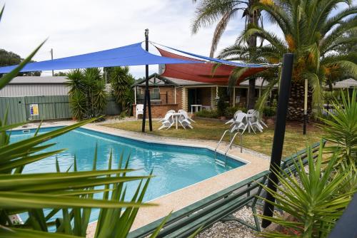 Culcairn库尔卡恩汽车旅馆的一座带蓝色帐篷的房屋前的游泳池