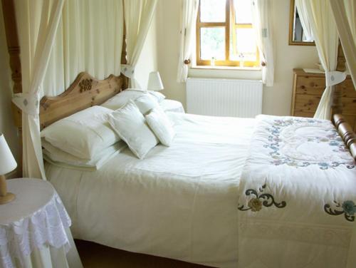 毕晓普斯堡The Byre的卧室配有白色的床和窗户。