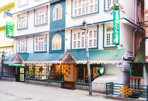 甘托克The Nettle and Fern Hotel Gangtok的建筑的一侧有绿色标志