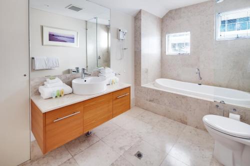 曼哲拉贝壳曼德拉酒店的一间带水槽、浴缸和卫生间的浴室