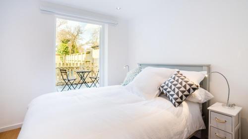 伯恩茅斯The Wing -Near to the beaches and Bournemouth University的卧室配有白色的床和窗户。