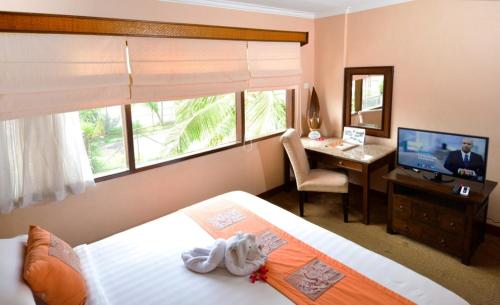 日惹嘉雅卡塔酒店及水疗中心客房内的一张或多张床位