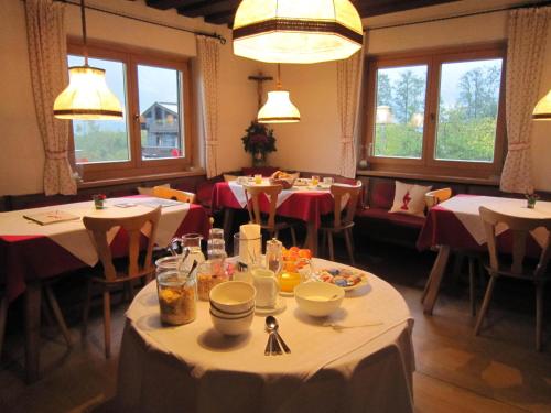 基茨比厄尔Pension Feiersinger的用餐室设有桌椅和窗户。