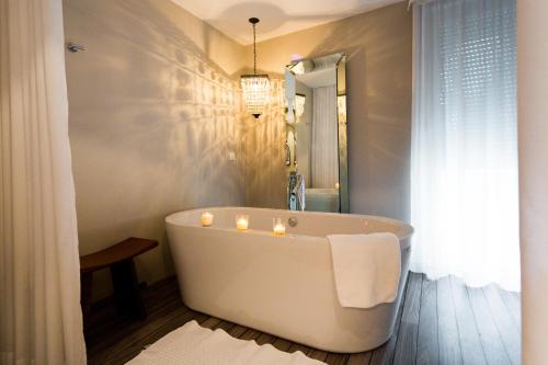 苏佩塔尔Waterman Svpetrvs Resort - All Inclusive的浴室配有带蜡烛的浴缸。